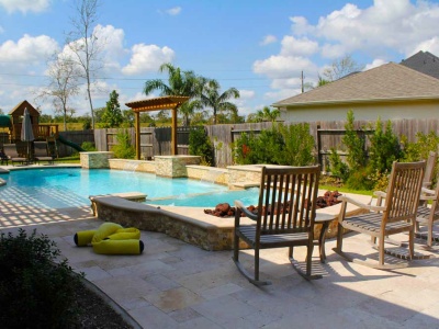 Grecian Style Pool and Raised Spa with Travertine Pavers, Raised Wall, and Natural Gas Fire Pit