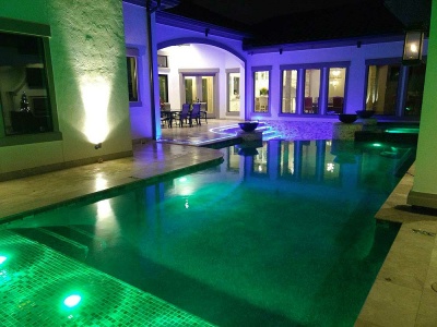 Modern Pool and Spa with Glass Tile, Marble Decking, Hammered Copper Natural Gas Fire Bowls, Led Strip Lighting, Glass Bead Plaster