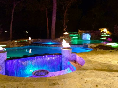 Multi Level Natural Rock Freeform Pool, Spa, and Grotto with Fire Bowls and Silver Travertine Paver